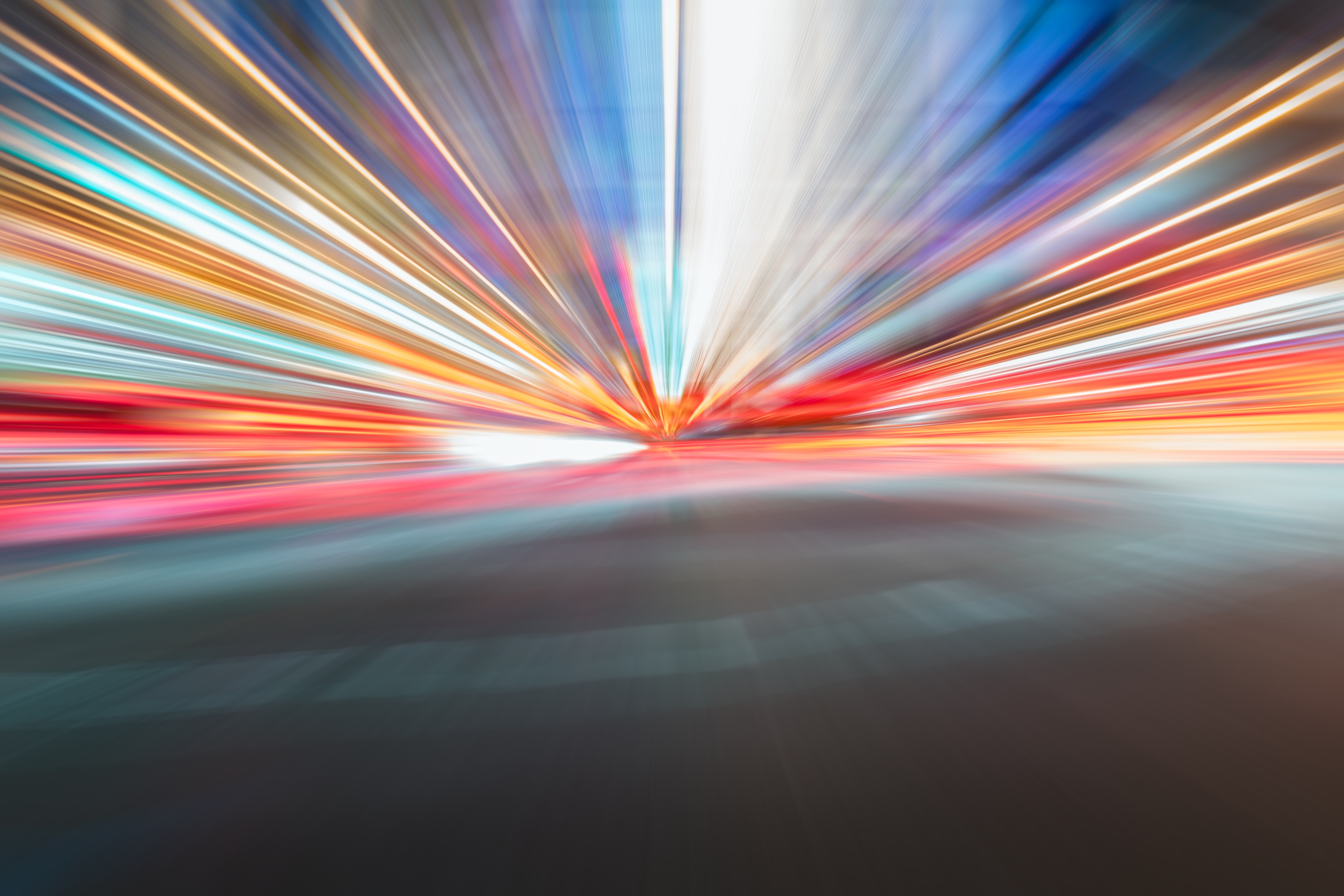 Light trails of moving cars on a road at night