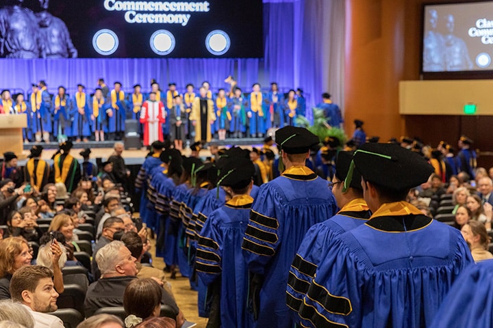 Graduating students lead a procession into the Commencement ceremony at Mayo Clinic