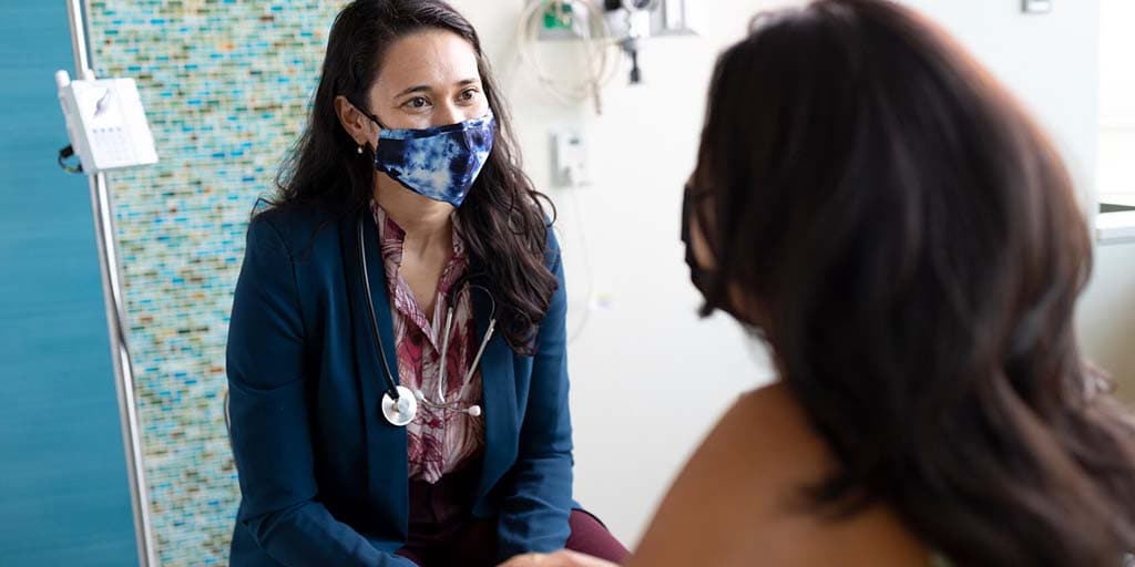 Medical student, Jennifer Talbott, spends time with a young patient at the Mayo Clinic infusion center in Arizona.