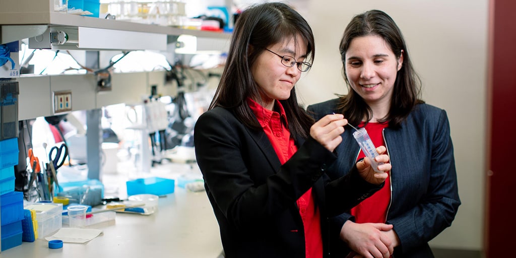 Two female physician researchers examining samples in the lab at Mayo Clinic