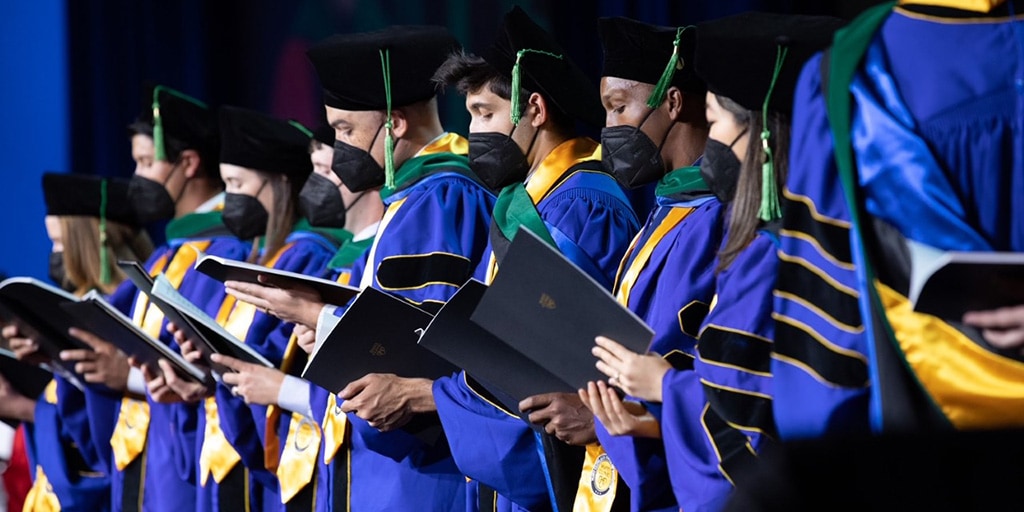 Graduates on stage at commencement in Arizona
