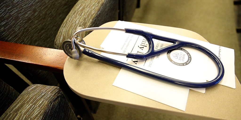 Close-up image of a stethoscope and ceremony program