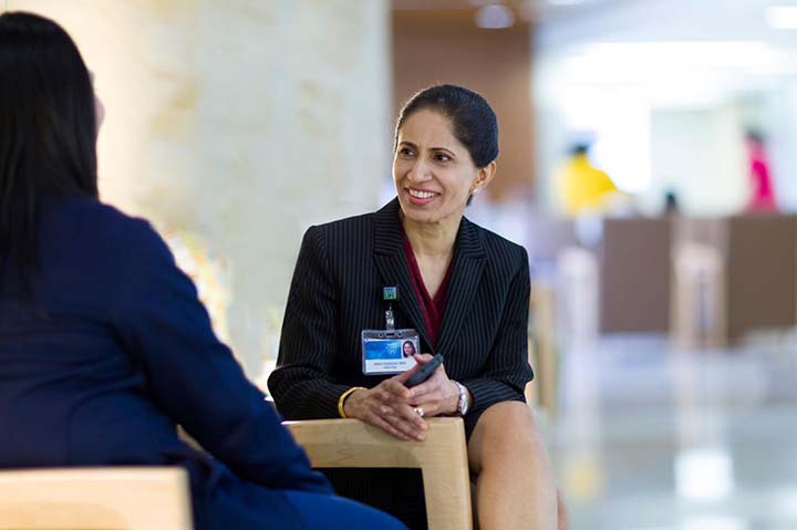 A manager smiles at a colleague during a meeting
