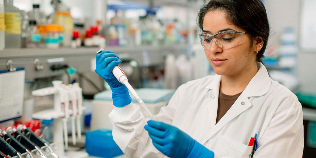Research student with pipette in a lab setting