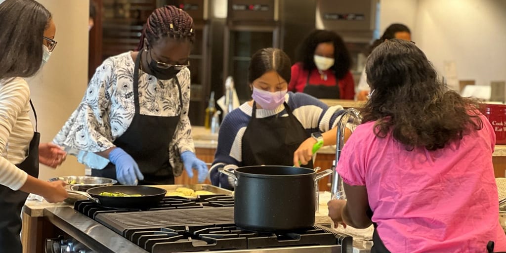 RISE for Youth students working together in the kitchen.