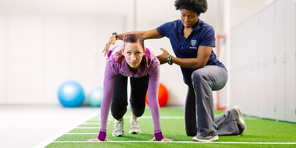 Mayo Clinic athletic trainer working with a sprinter