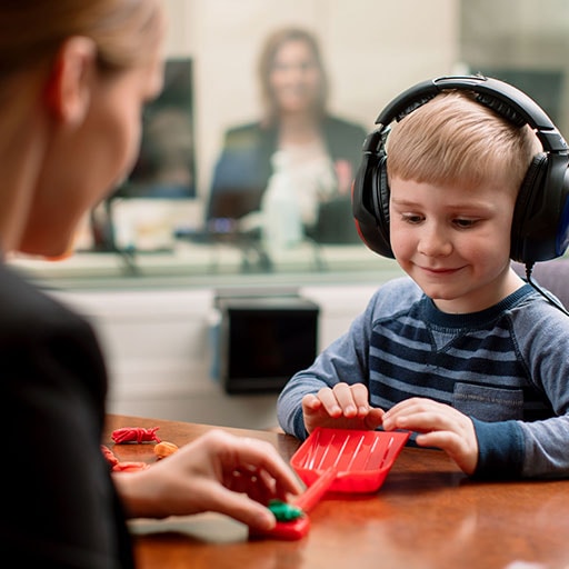 Mayo Clinic audiologist conducting a hearing test on a child