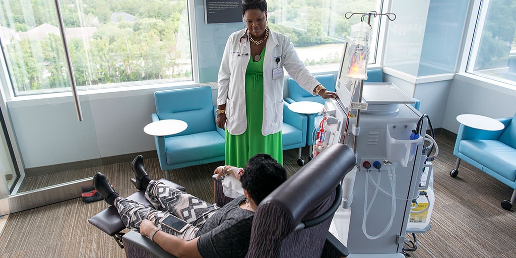 Mayo Clinic hemodialysis technician monitoring a dialysis patient