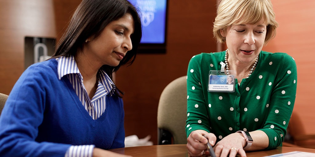 Mayo Clinic genetic counselor reviewing paperwork with a patient