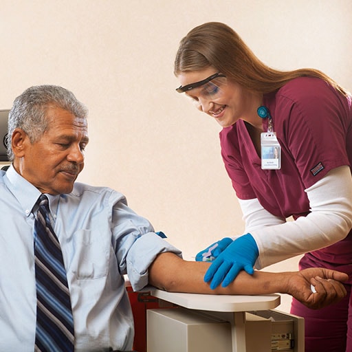Mayo Clinic phlebotomist drawing blood from a patient