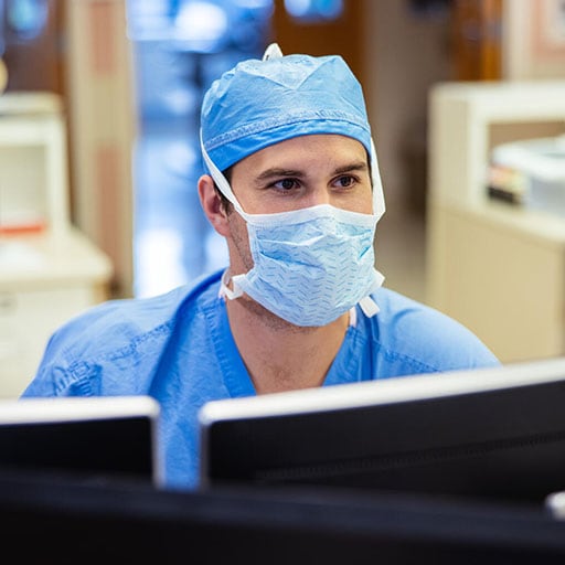 A perioperative nurse at Mayo Clinic documents patient notes on the computer