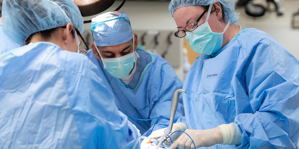 Gynecology PA fellow and faculty performing surgery in the operating room
