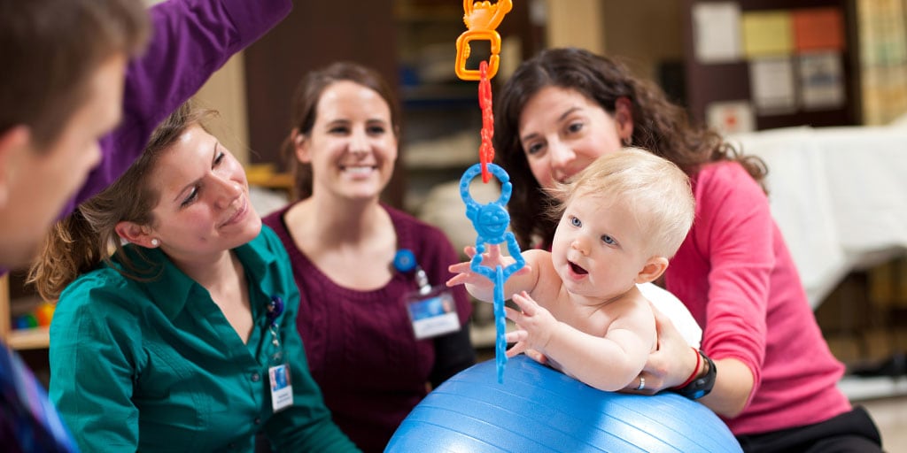 Mayo Clinic health sciences students playing with a baby