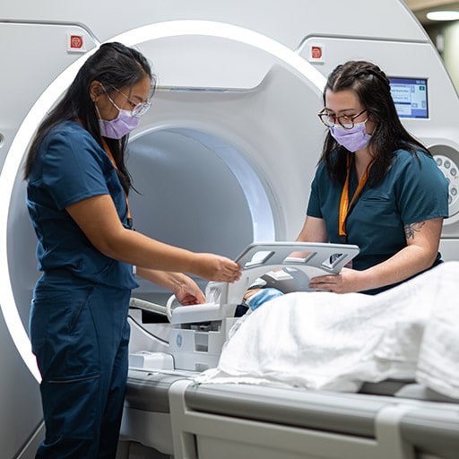 Mia Rossi and Amela Hamzagic practice Magnetic Resonance Imaging (MRI) techniques at Mayo Clinic in Rochester, Minnesota.