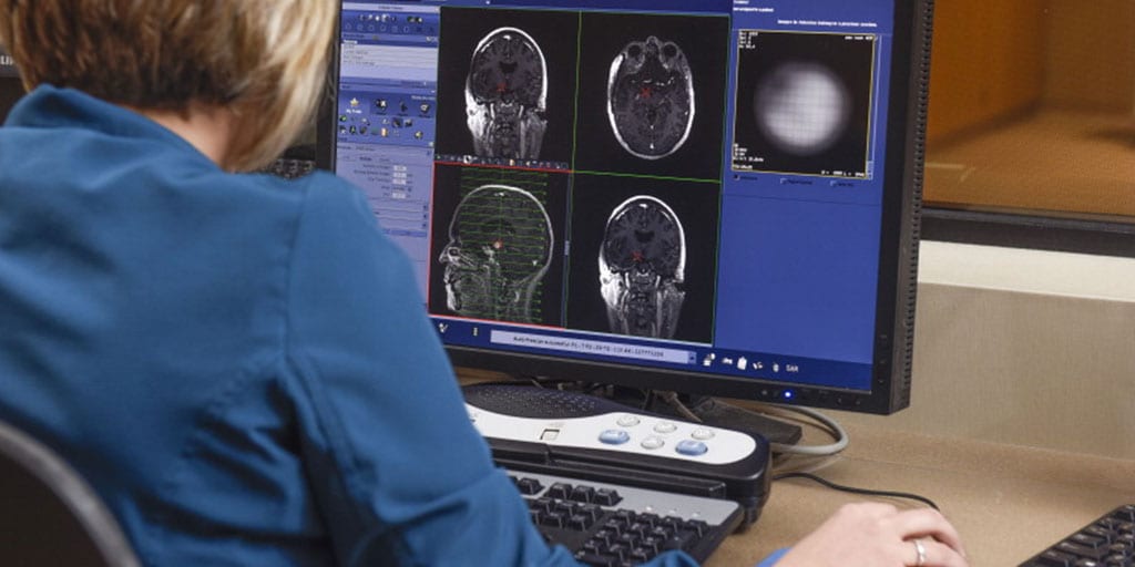 MRI technologist reviewing MRI results on computer
