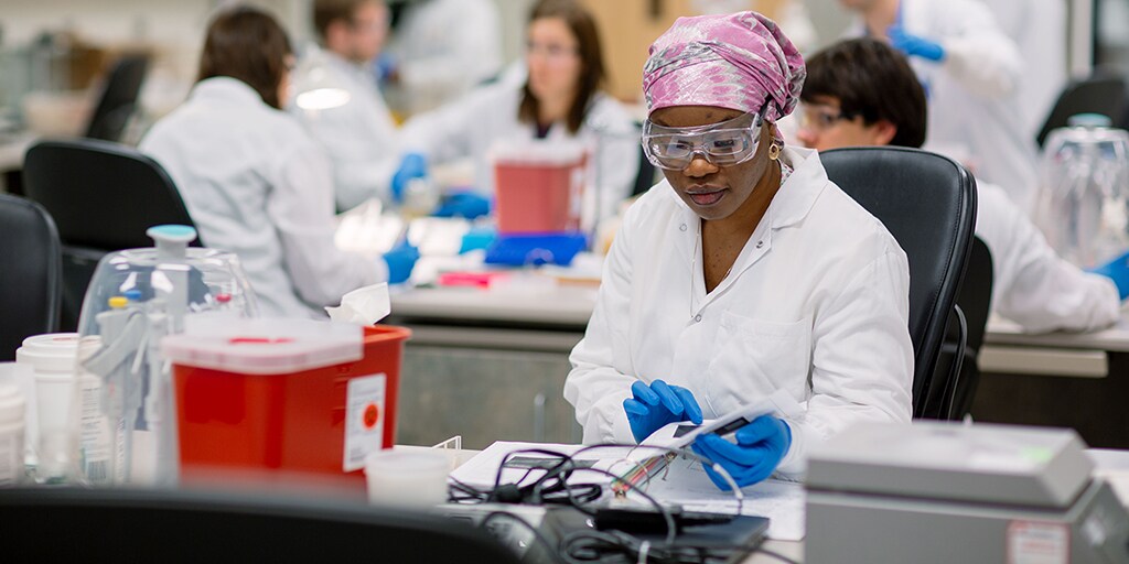 A Mayo Clinic medical lab scientist examining a specimen