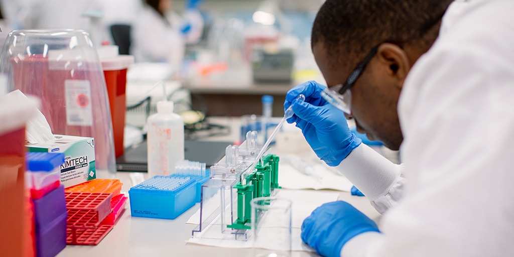 A Mayo Clinic medical lab scientist examining a specimen