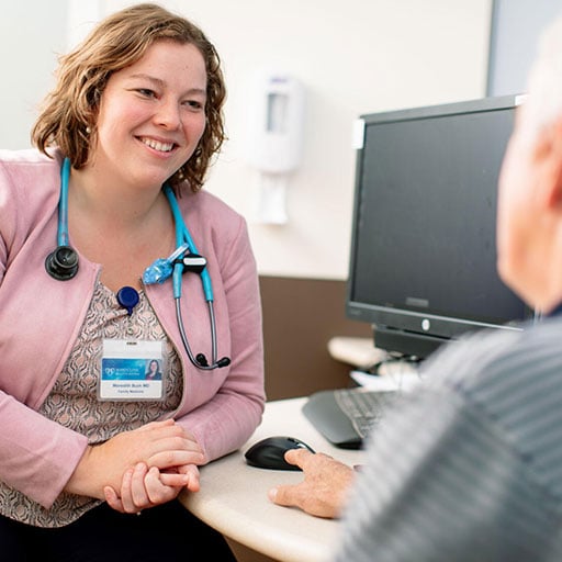 Advanced practice provider talking with patient in a physician office setting
