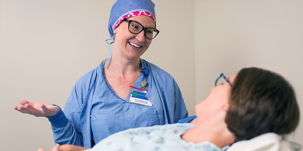 A Mayo Clinic nurse anesthetist talking with a patient