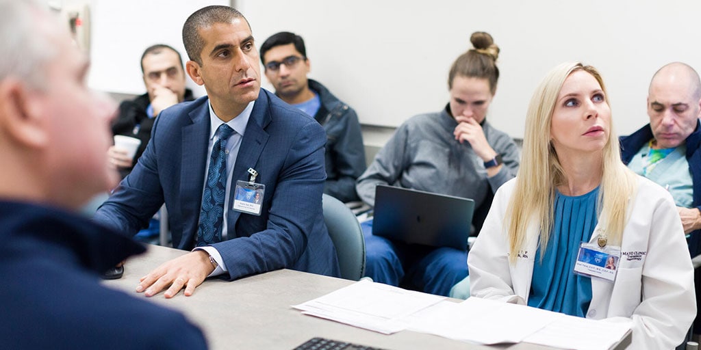 A group of trainees sitting in classroom, looking at screen