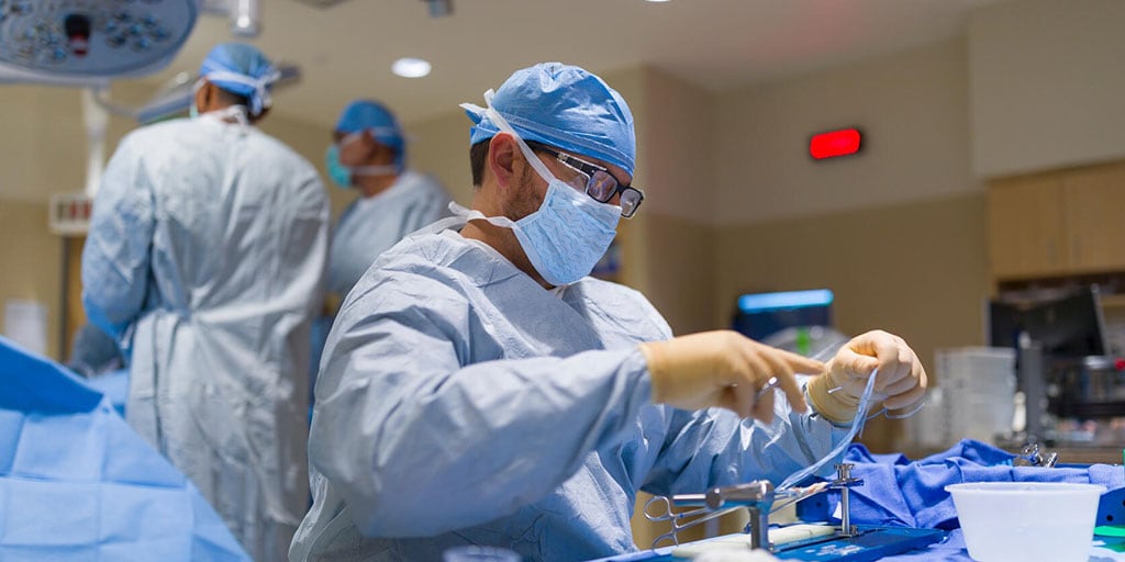 Orthopedic surgeon preparing graft on the back table during a knee arthroscopic procedure at Mayo Clinic in Phoenix, Arizona.