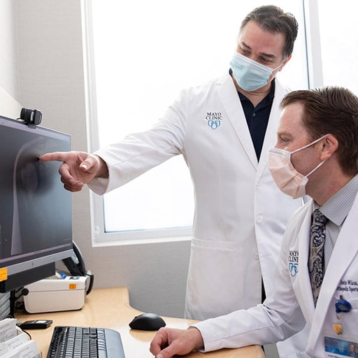 Kostos Economopoulos, M.D. and Justin Wilcox, P.A.-C., of Orthopedic Surgery and Sports Medicine, review an x-ray at Mayo Clinic in Phoenix, Arizona.