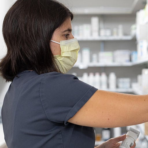A pharmacy intern checks on medications in the pharmacy clinic