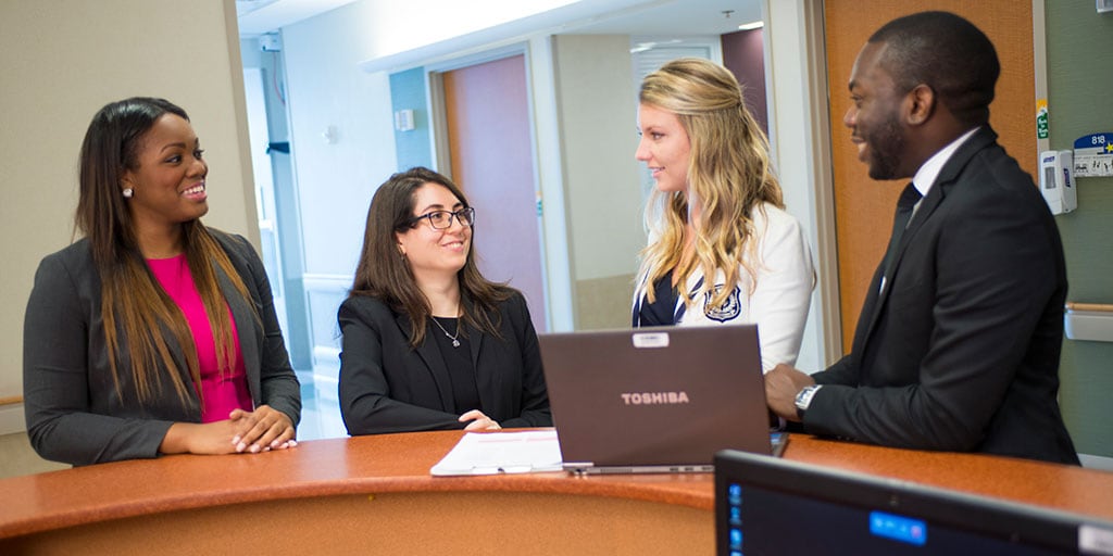 Mayo Clinic pharmacy residents speak and collaborate in the hallway