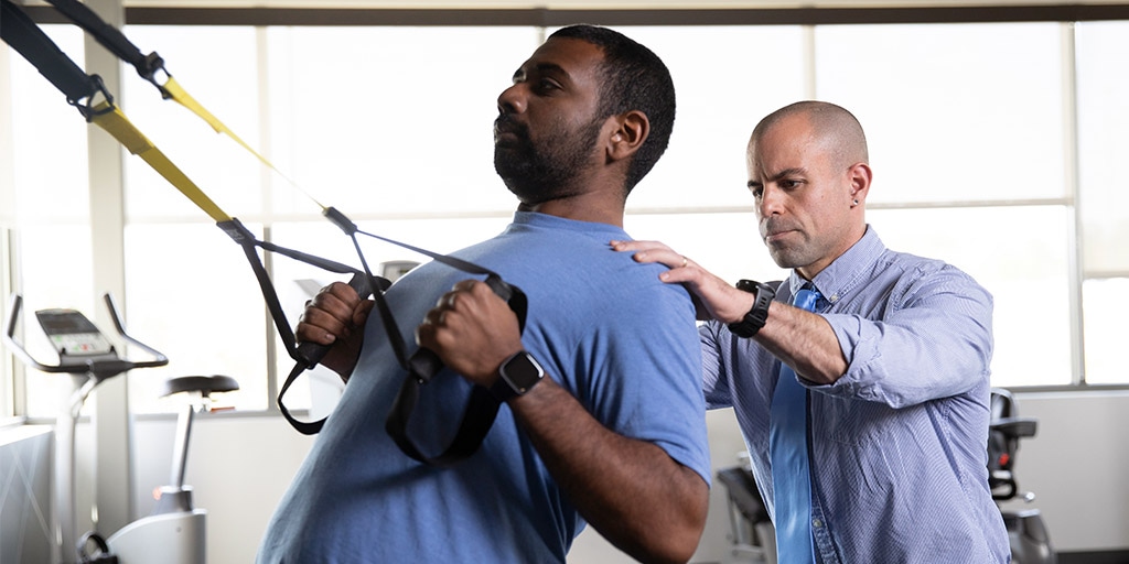 Physical therapy resident works with a patient at a rehabilitation clinic