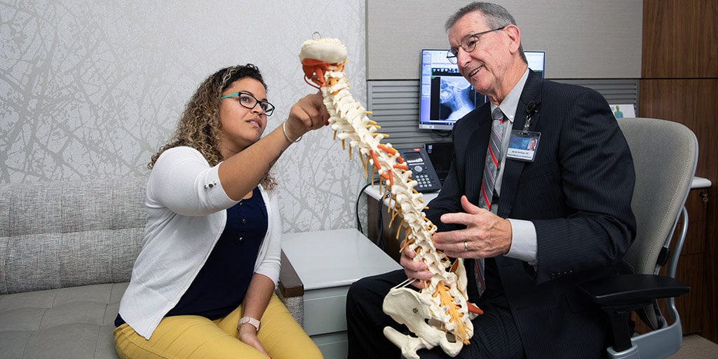 A Mayo Clinic physical therapist with a spine model