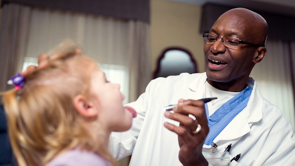 Physician Assistant interacting with child patient during exam