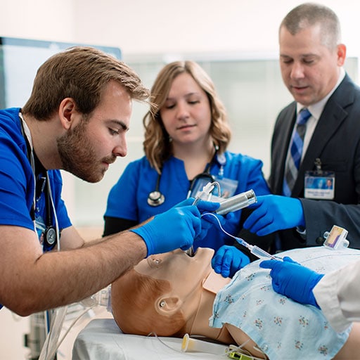 Mayo Clinic respiratory therapy student practicing a procedure with a mannequin