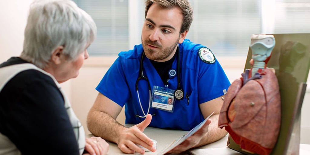 Mayo Clinic respiratory therapy student explaining a procedure to a patient