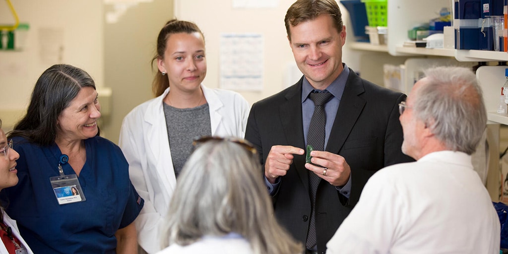 Speech language pathologist speaks to fellows in the clinic