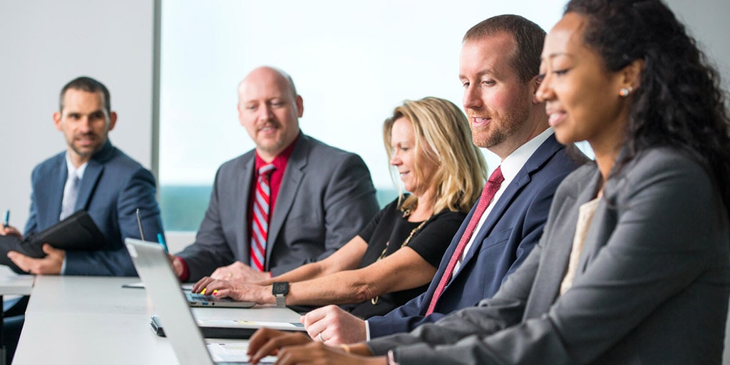 Administrative interns talk around a table at Mayo Clinic in Jacksonville, Florida.