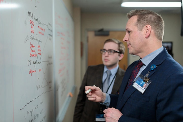 Adult Neurology residents discussing neurology using a whiteboard at Mayo Clinic in Rochester, Minnesota.