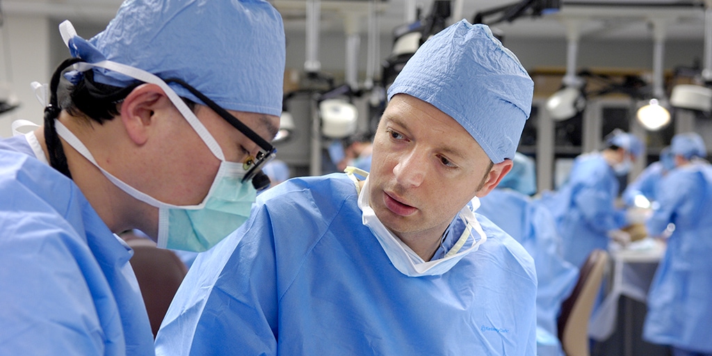 2 adult reconstructive surgeons conversing