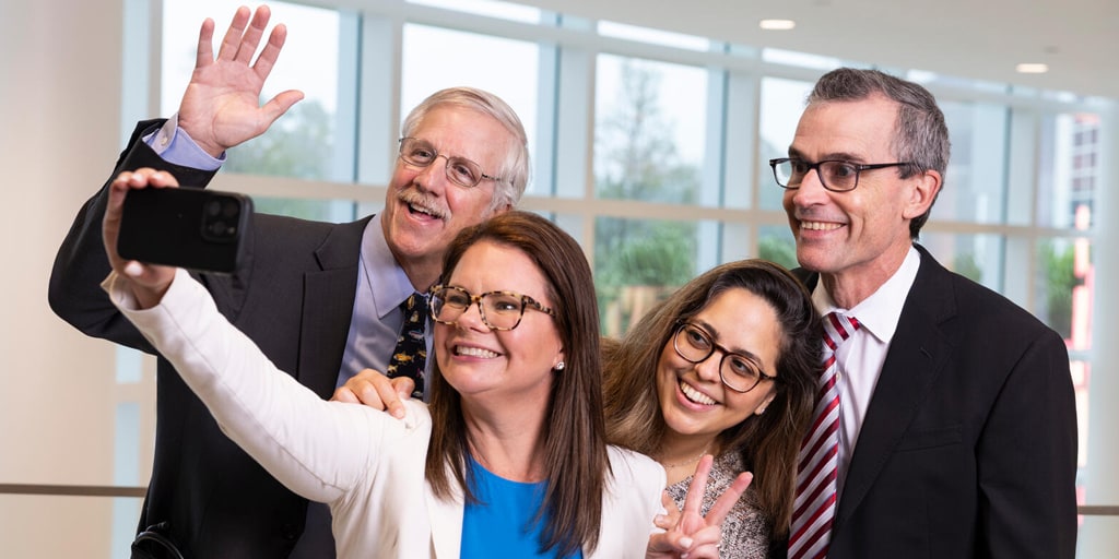 Four members of faculty from the Advanced Inflammatory Bowel Disease Fellowship program at Mayo Clinic in Jacksonville, Florida, used a cell phone and took a silly group selfie photo.