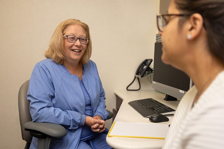A nurse from the Advanced Inflammatory Bowel Disease Fellowship program at Mayo Clinic in Jacksonville, Florida, was in a doctor's office having a discussion with a patient.