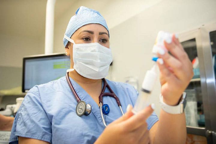 Anesthesiology resident drawing up medication in a syringe at Mayo Clinic in Jacksonville, Florida.