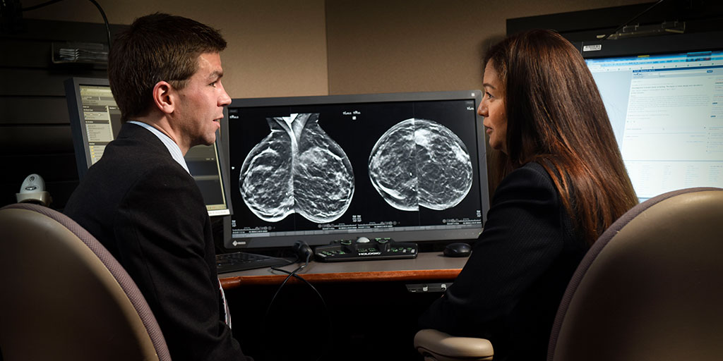 Two doctors reviewing radiologic images