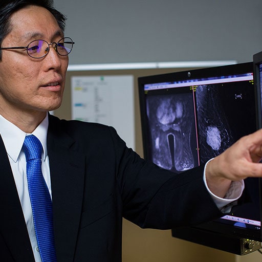 Physician and fellow examining images in breast oncology