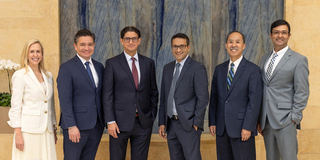 Six doctors from the Cardiology, Advanced Heart Failure and Transplant Cardiology Fellowship program in Jacksonville, Florida, pose for a group photo in a building at Mayo Clinic.