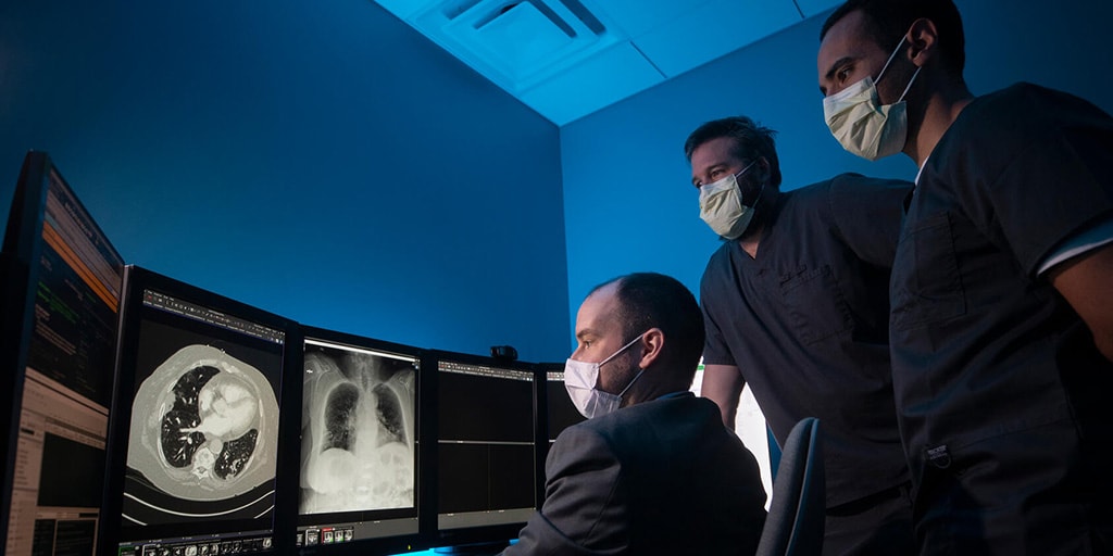 Cardiothoracic Imaging Fellowship in Jacksonville, Florida, three doctors review scans on monitors.