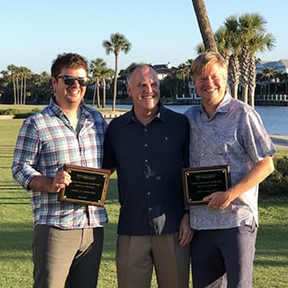 Rolf Grage, M.D. standing next to two colleagues.