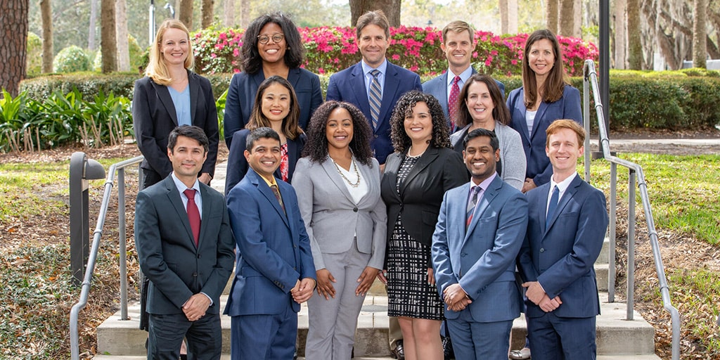 Thirteen people from the Cardiovascular Diseases Fellowship program at Mayo Clinic in Jacksonville, Florida, stood outside on steps for a group portrait.
