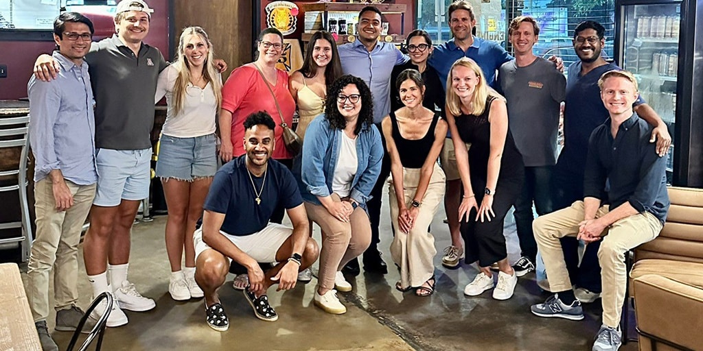 Fifteen people from the Cardiovascular Diseases Fellowship program at Mayo Clinic in Jacksonville, Florida, gathered inside a restaurant for a group photo.
