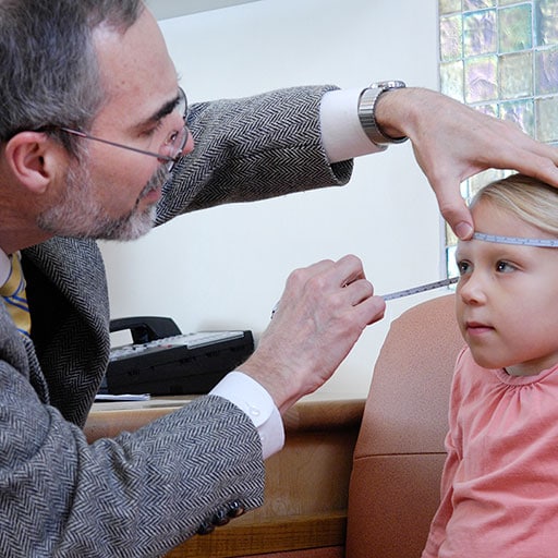 Physician in child neurology examines a young patient
