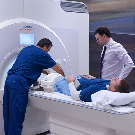 Two people using radiology equipment