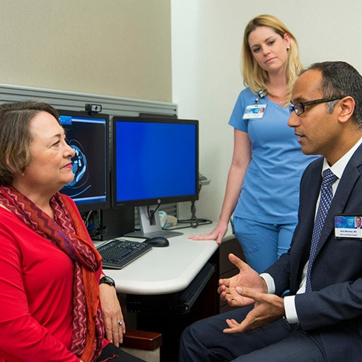 Colon and Rectal Surgery resident and faculty member speak with a patient in a clinical room at Mayo Clinic in Jacksonville, Florida.
